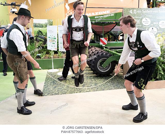 Members of a traditional costume group from Ramsau, Germany jump rope on the second to last day of the International Green Week at the fairgrounds in Berlin