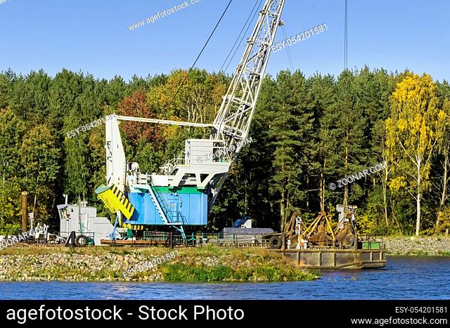 Environmental protection. On the river Bank mechanism for cleaning the river bottom and deepening the river for navigation