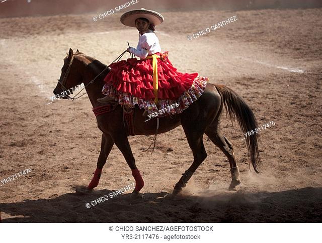 "An escaramuza rides her horse before competing in an Escaramuza in the Lienzo Charros el Penon, Mexico City, Sunday, January 19, 2013