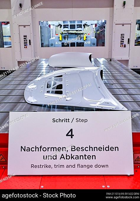 09 October 2021, Brandenburg, Grünheide: The press's huge facility for producing body parts for a Tesla Model Y is seen at the open house in a production hall...