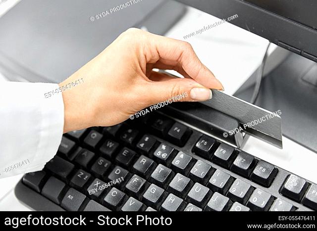 close up of pharmacist's hand swiping credit card