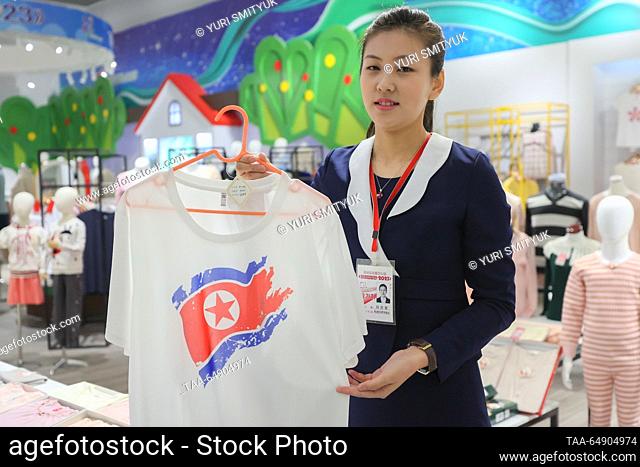 NORTH KOREA, PYONGYANG - NOVEMBER 16, 2023: An employee holds a T-shirt at an exhibition of North Korean consumer goods. The Russian delegation has arrived in...