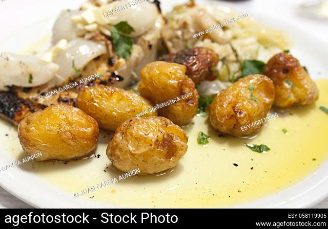 Roasted codfish with potatoes or Bacalhau a Bras. Portuguese traditional food