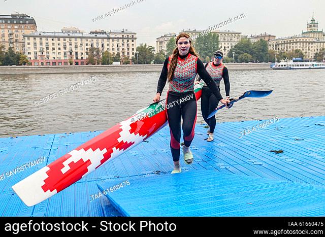 RUSSIA, MOSCOW - SEPTEMBER 2, 2023: Athletes carry a kayak during the Goodwill Cup international canoeing and kayaking competition on the Moskva River