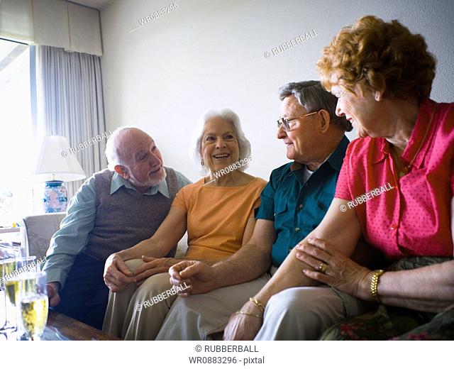 Close-up of two senior couples smiling together