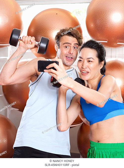 Couple taking picture together in gym
