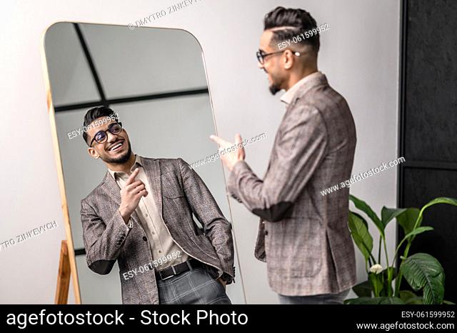Stylish man. A good-looking young stylish man at the mirror