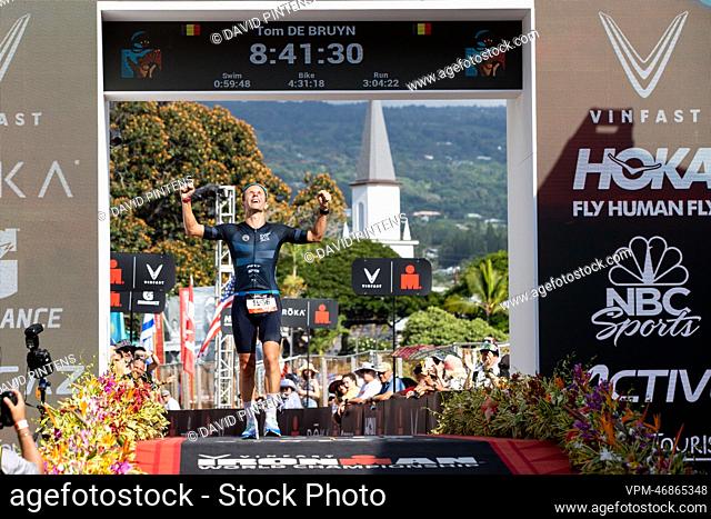 Belgian triathlete Tom De Bruyn celebrates as he crosses the finish line to win the Hawaii Ironman men's 35 to 39 age group triathlon race