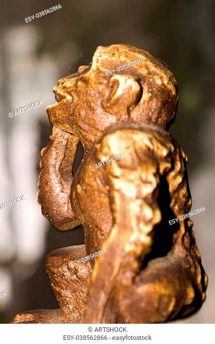 Macro of small wooden statuette of monkey