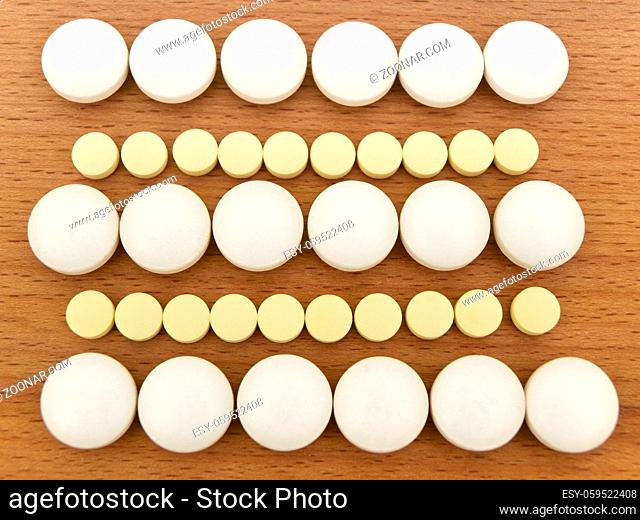 row of different tablets at wooden background