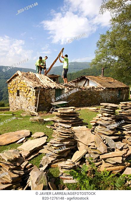 Group of young people working in the reconstruction of an old country house, Aizkorri Natural Park, Gipuzkoa, Euskadi, Spain