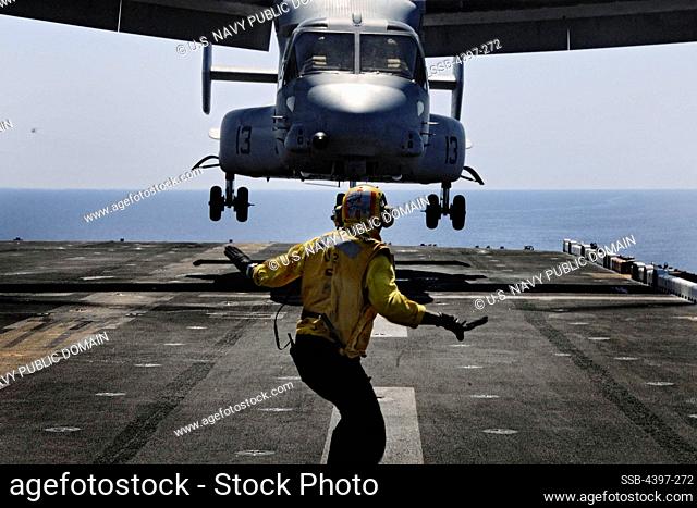 Landing Signalman Guides Osprey Onto Flight Deck