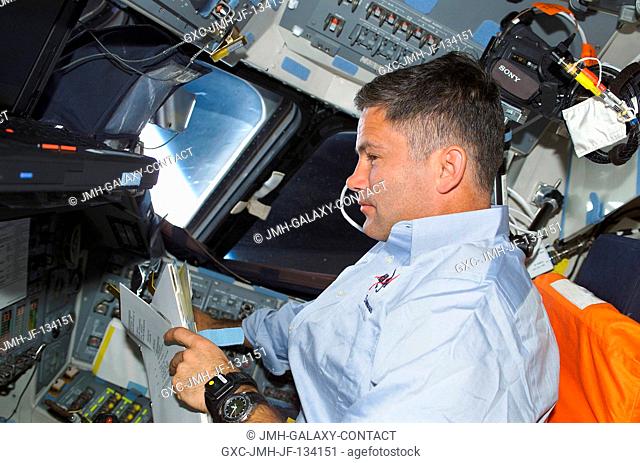 Astronaut Paul S. Lockhart, pilot, works at the pilot's station on the flight deck of the Space Shuttle Endeavour during the second day of STS-113 activity