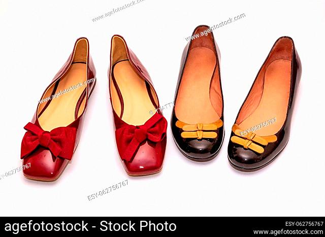 Shiny female patent leather ballerina flat shoes with decorative bows isolated on white background