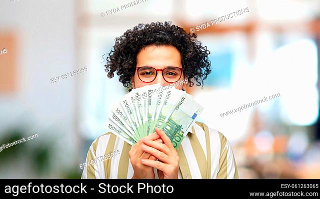 happy man with euro money at office