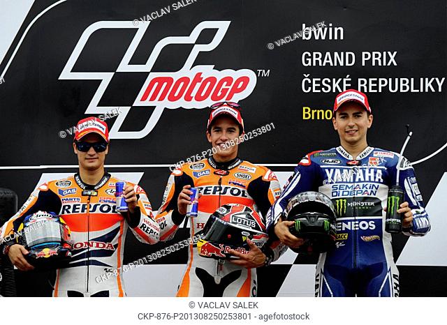 Winner of MotoGP class Marc Marquez of Spain (centre), second placed Dani Pedrosa of Spain (left) and third placed Jorge Lorenzo of Spain (right) celebrate...
