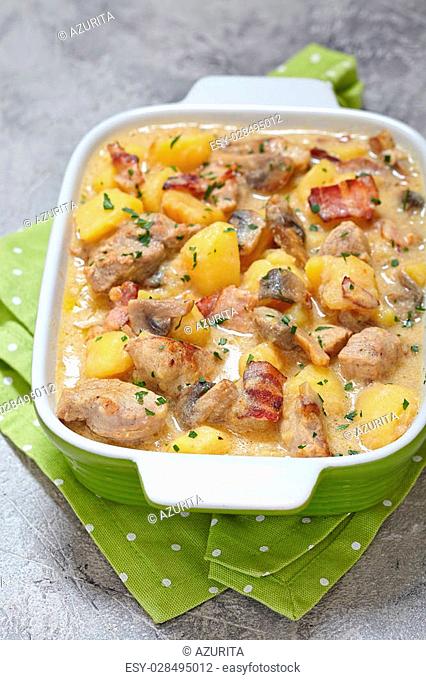 Potato stew with pork, mushrooms and bacon in sour cream sauce