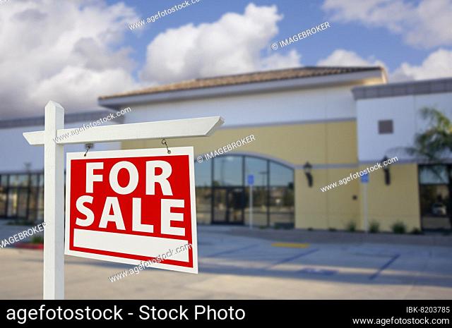 Vacant retail building with for sale real estate sign in front