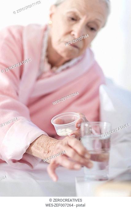 Patient lying in bed taking medication