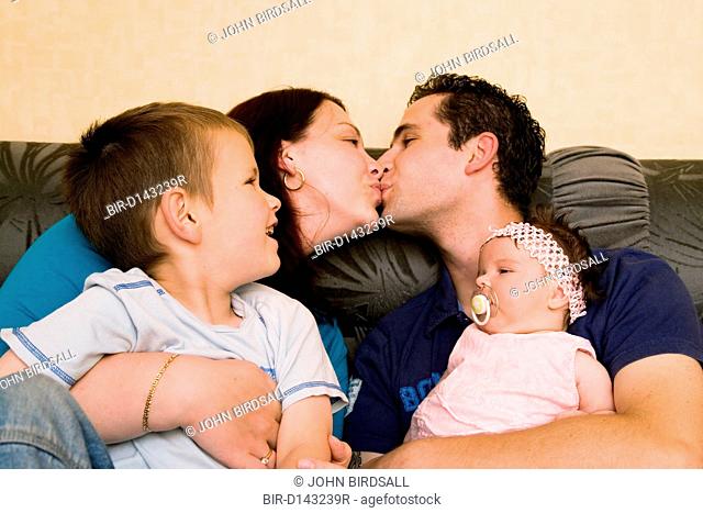 Polish couple showing affection whilst children look on