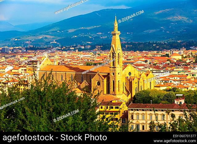 City aerial view with Basilica Santa Croce tower and houses in Florence, Italy