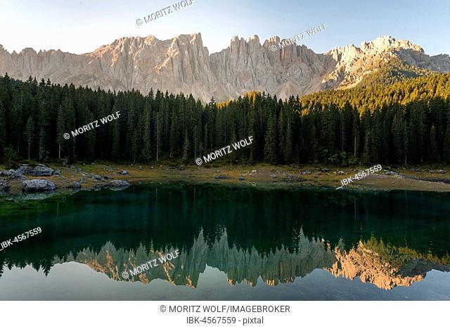 Morning atmosphere, Latemar group reflected in the Lake Carezza, Lago di Carezza, mountaintop of the Torre Diamantidi, eastern Latemarspitze, Col Coron