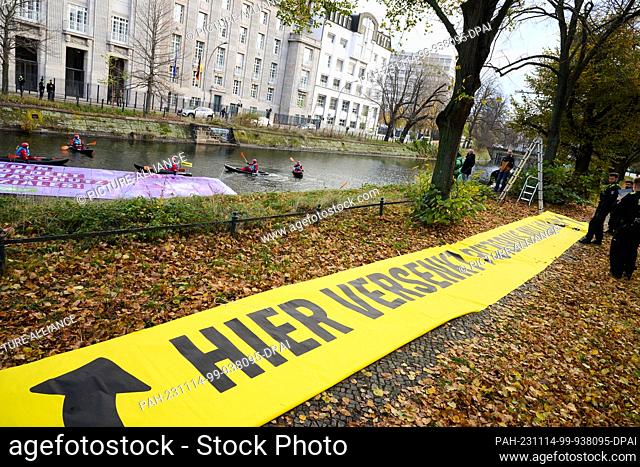 14 November 2023, Berlin: ""Pistorius sinks billions here"" is written on a yellow Greenpeace banner in front of the Federal Ministry of Defense