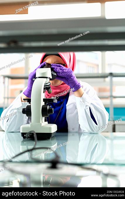 muslim lab worker doing an analysis