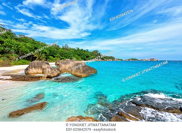 Beautiful landscape of blue sky sea sand and white waves on beach near the rocks during summer at Koh Miang island in Mu Ko Similan National Park