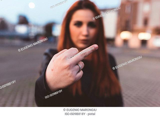 Woman showing middle finger to camera