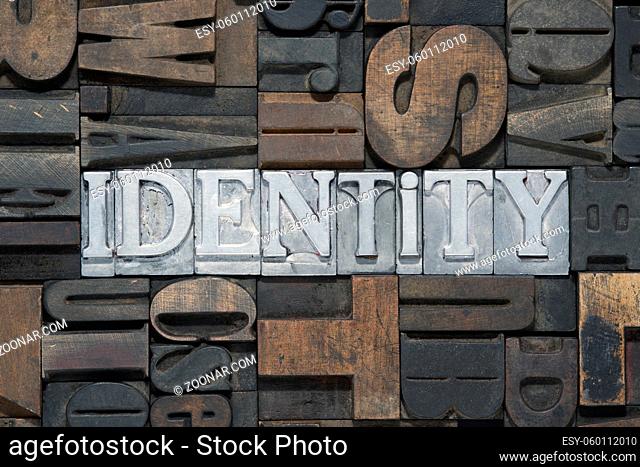 identity word made from metallic letterpress blocks in mixed wooden letters