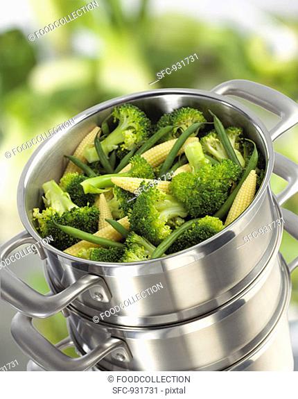 Broccoli, baby corn-cobs and green beans in steaming pan
