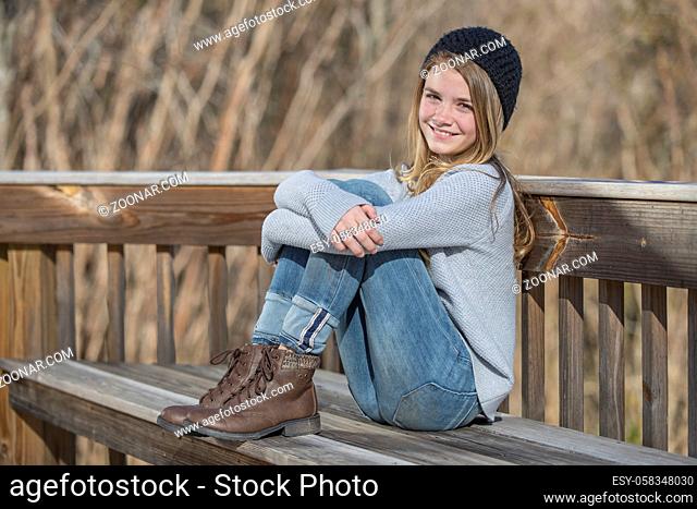A beautiful young teenage blonde girl enjoying a beautiful day