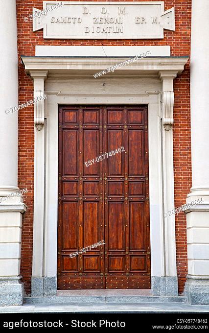 brass brown knocker and wood door in a church crenna gallarate varese italy