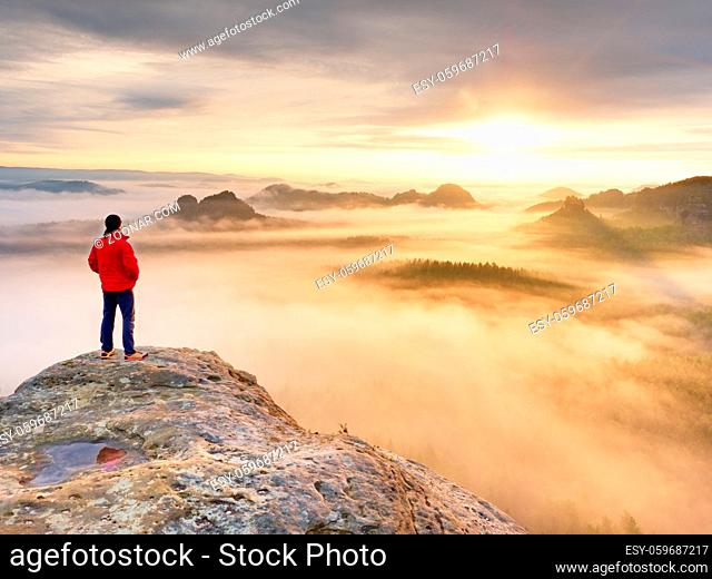 Silhouette of Young Confident and Powerful Man Standing with Hands on Hips, Hidden Sun. Photo with Copy Space