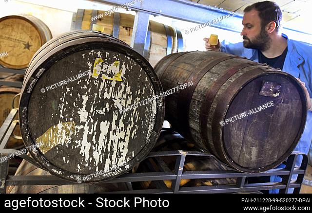 20 December 2021, Saxony-Anhalt, Zeitz: In the Zeitzer Whisky Manufaktur, owner Daniel Rost tests whisky that has been maturing for several years in barrels...