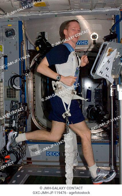 European Space Agency astronaut Frank De Winne, Expedition 21 commander, exercises on the Combined Operational Load Bearing External Resistance Treadmill...