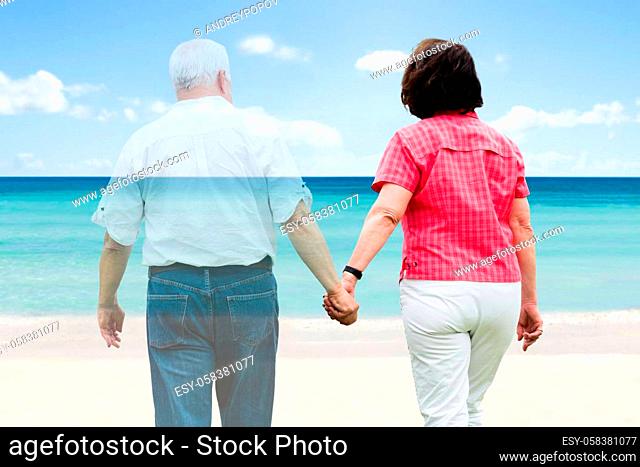 Senior Couple Holding Hands Walking At Beach
