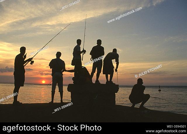 Fishermen at sunset by the Malecón in Havana, Cuba