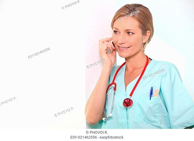 Female nurse on mobile telephone
