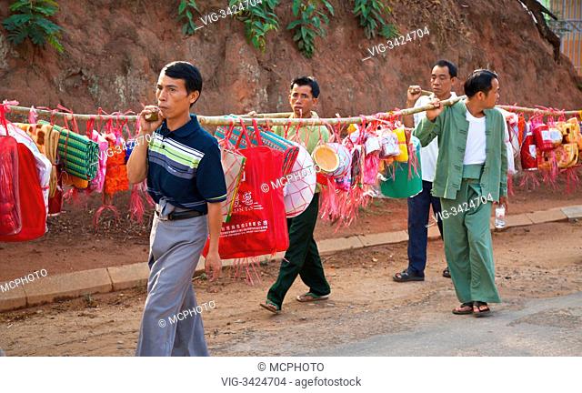 PROCESSION carrying houshold items for young men entering a Buddhist monastery in KENGTUNG also known as KYAINGTONG - MYANMAR - 30/04/2012