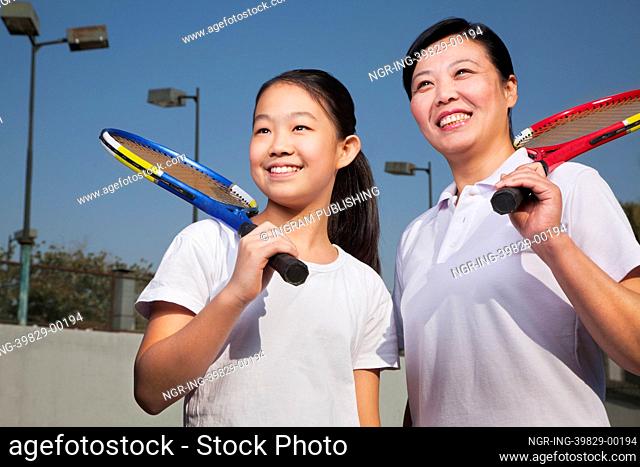 Mother and daughter playing tennis
