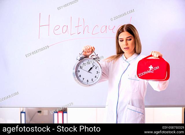 Young female doctor standing in front of the white board