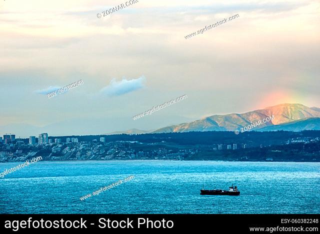 Sunset and a rainbow over the Valparaiso bay, a view of the resort town of Vina del Mar, Chile