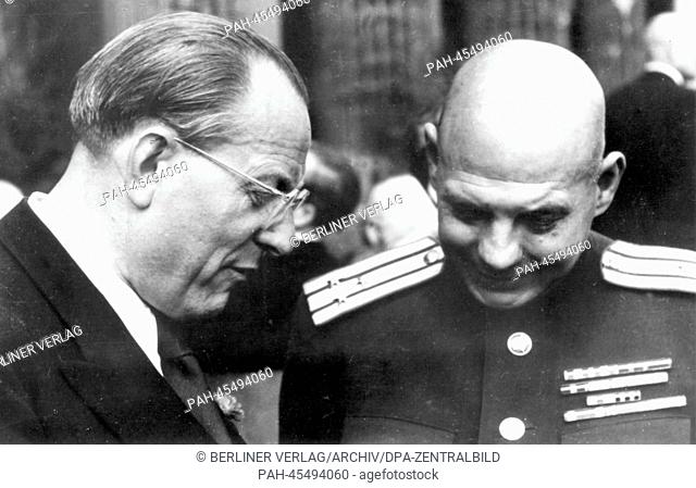 Chairman of the newly founded SED Communists party, Otto Grotewohl (L), speaks with the director of the Propaganda Administration of the Soviet Military...