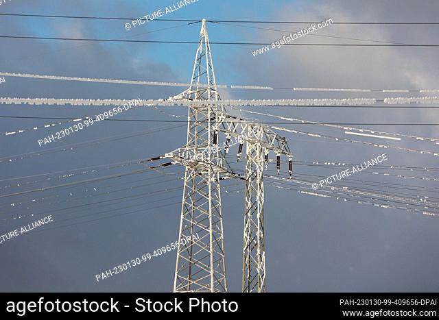 PRODUCTION - 30 January 2023, Saxony-Anhalt, Hüttenrode: Power pylons are located near the substation in Hüttenrode on the L94 highway between Hüttenrode and...