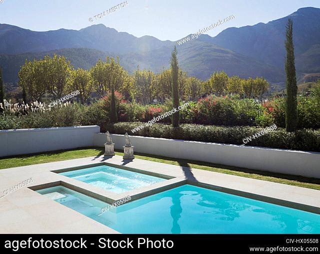 Sunny, idyllic lap pool and hot tub with tranquil mountain view