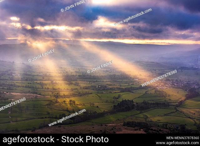 Rays of light cut through early morning mist at Mam Tor in the Derbyshire Peak District, United Kingdom Featuring: Atmosphere Where: Castleton