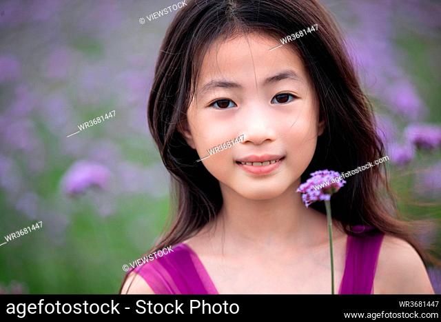 Happy little girl in the flower sea