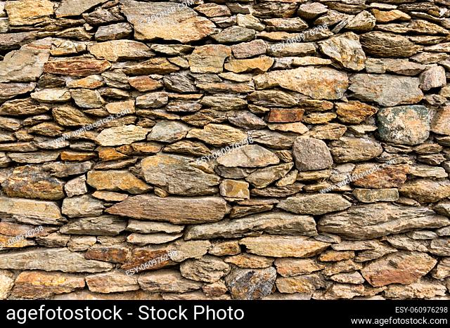 Dry stone wall masoned with natural boulders